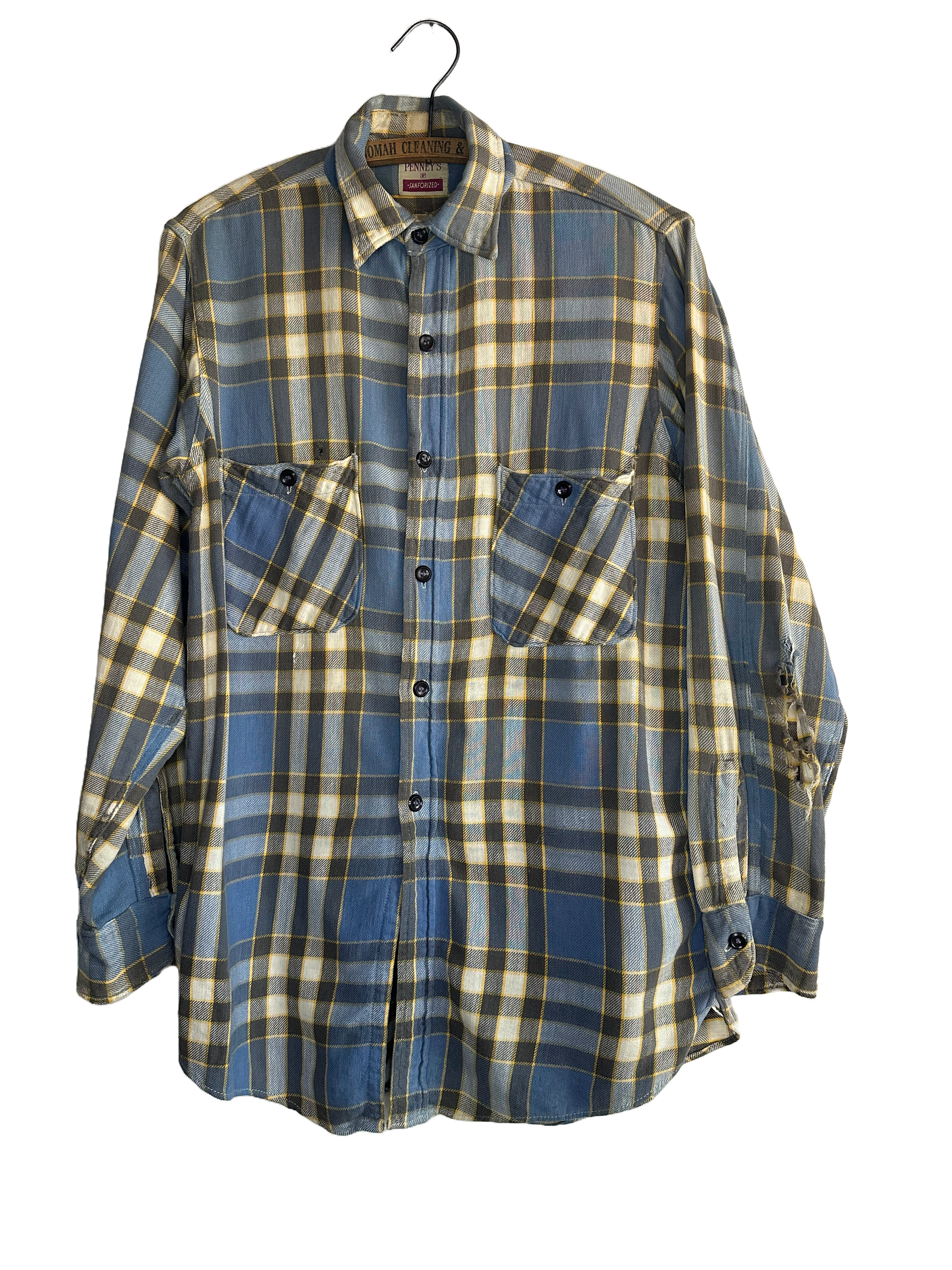 1950s flannel shirt by penneys. 2 pockets in front, plaid pattern of blue yellow and black. black buttons 