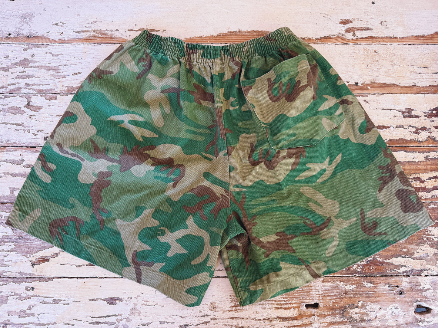 Camouflage shorts on a wooden surface