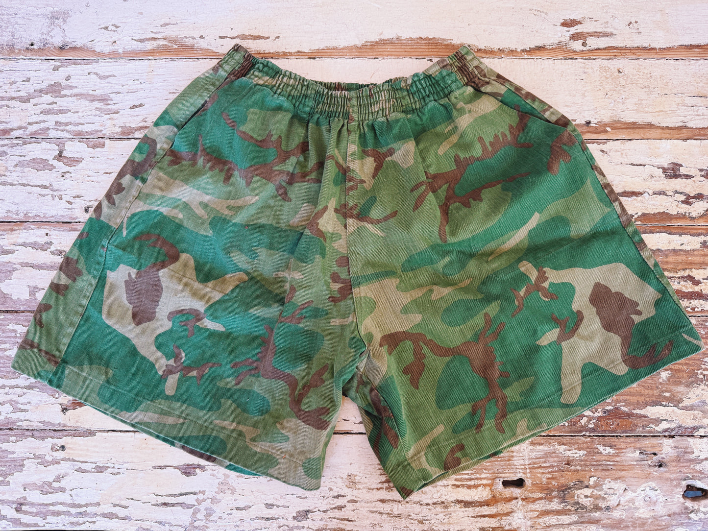 Camouflage shorts on a wooden surface