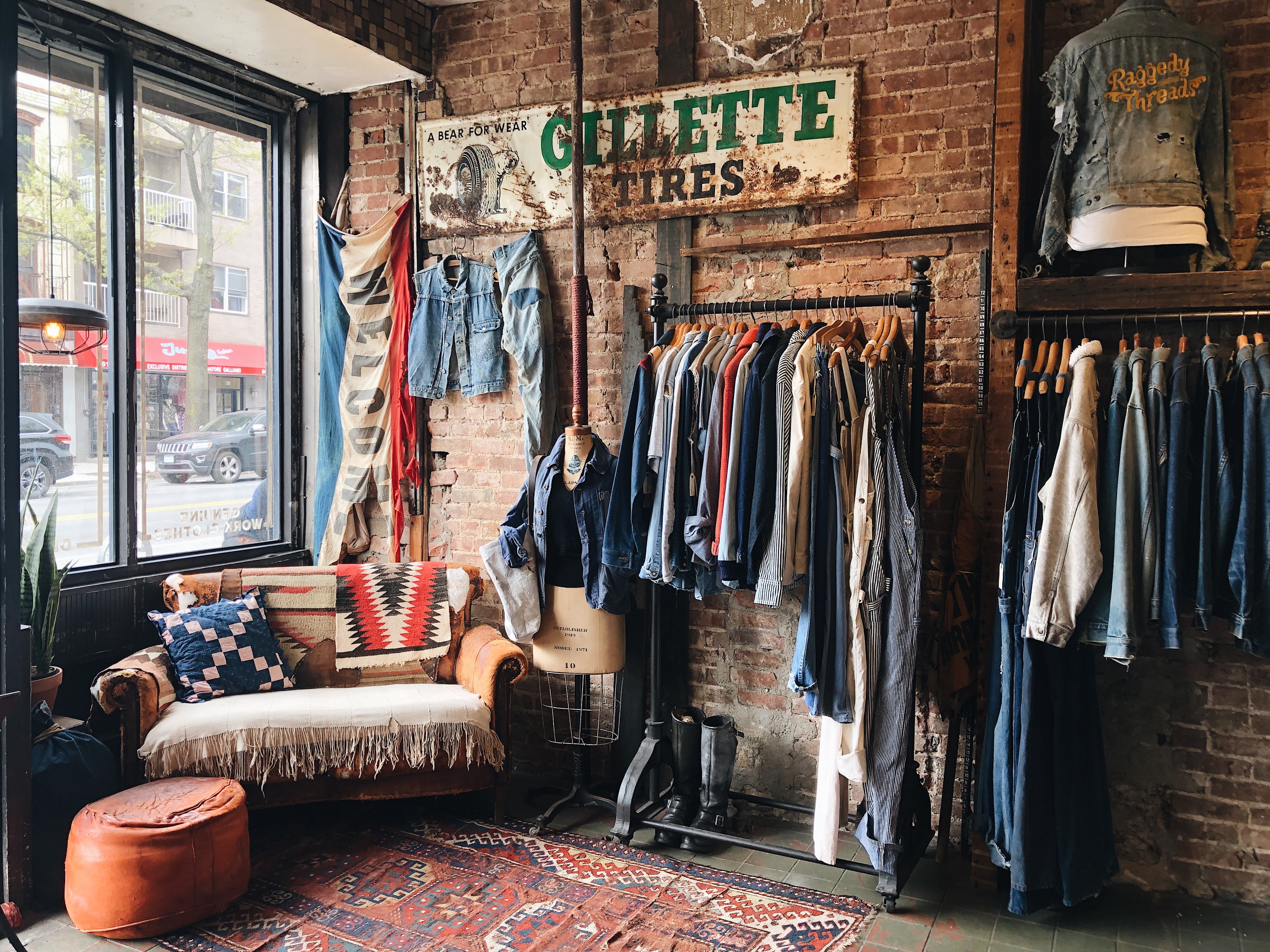 Front view of store with clothing racks of vintage denim and overalls