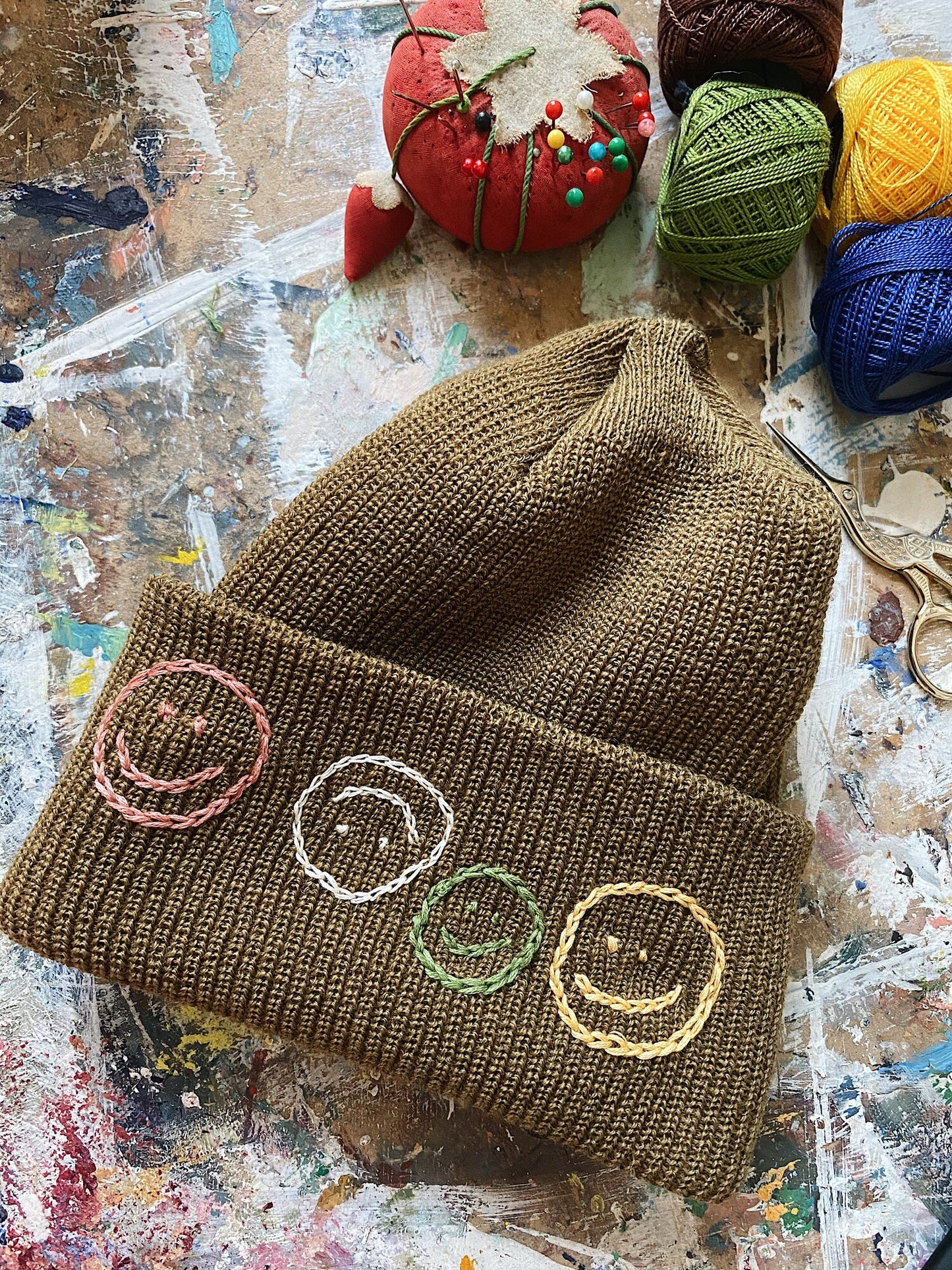 wool beanie with colorful embroidery smiley faces