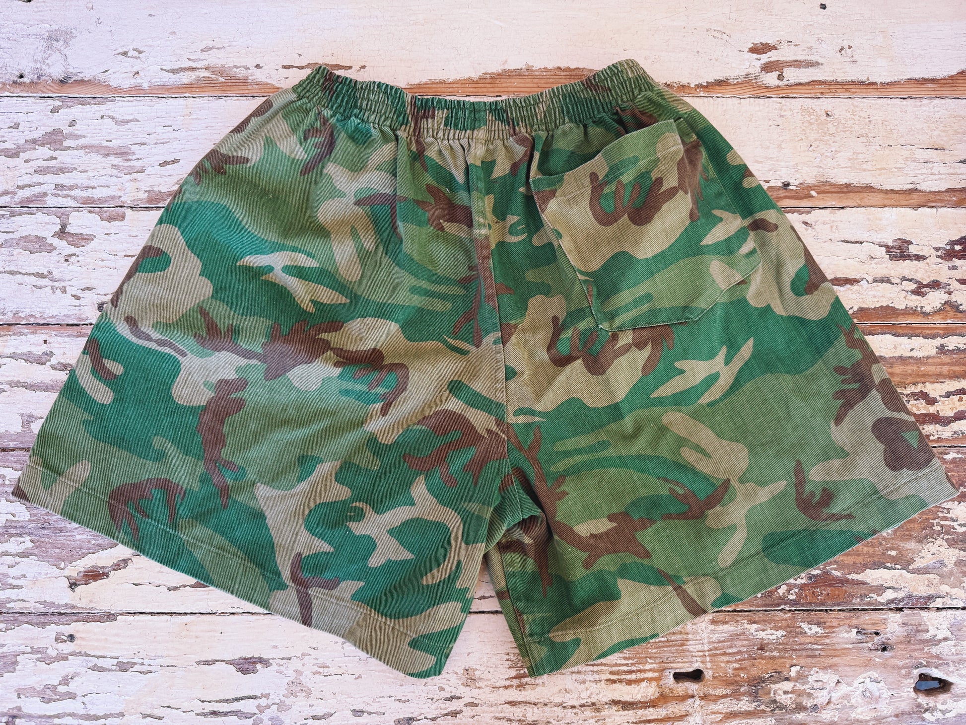 Camouflage shorts on a wooden surface